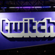 A Twitch banner hangs in a convention hall.
